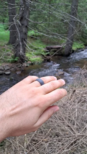 Adventure Dark Gray Silicone Wedding Ring displayed on a natural background, emphasizing its rugged, modern design